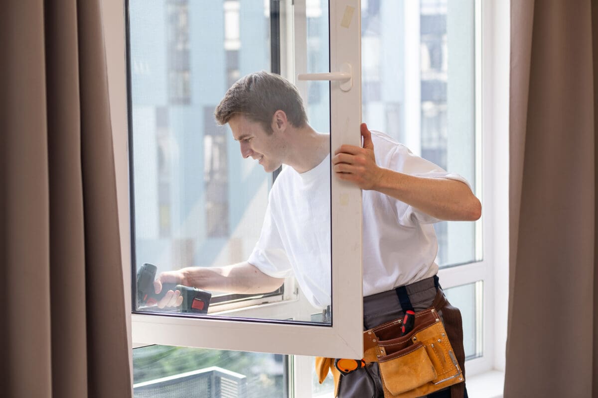 a repairman fixing an apartment window