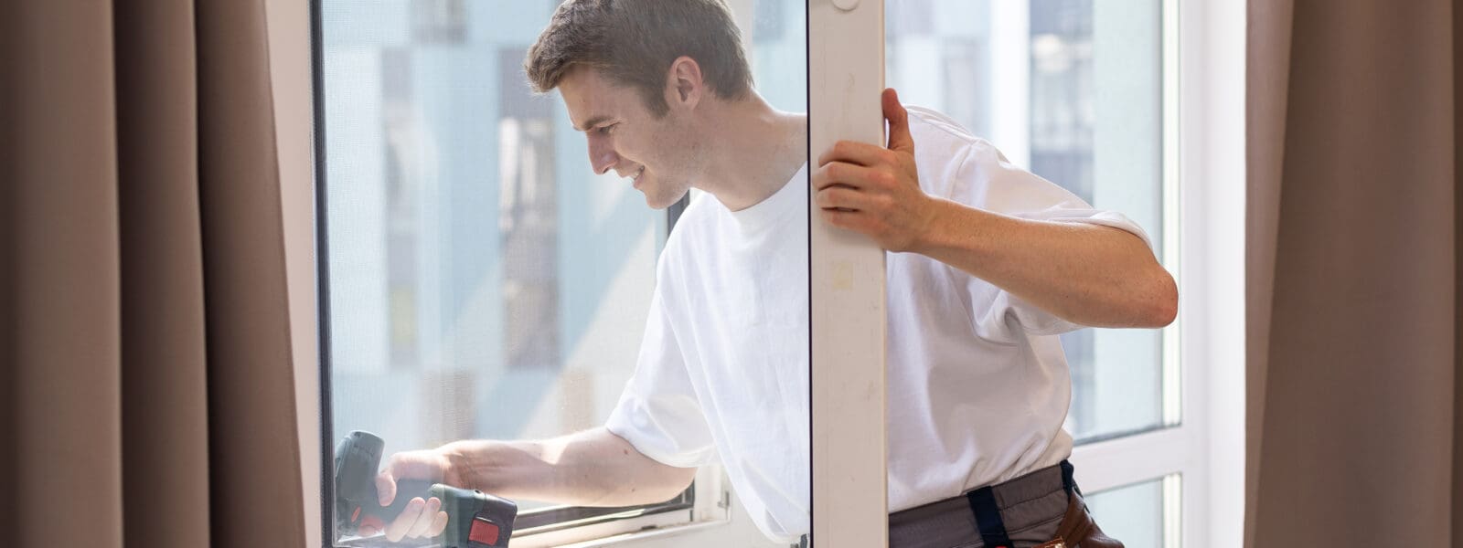 a repairman fixing an apartment window