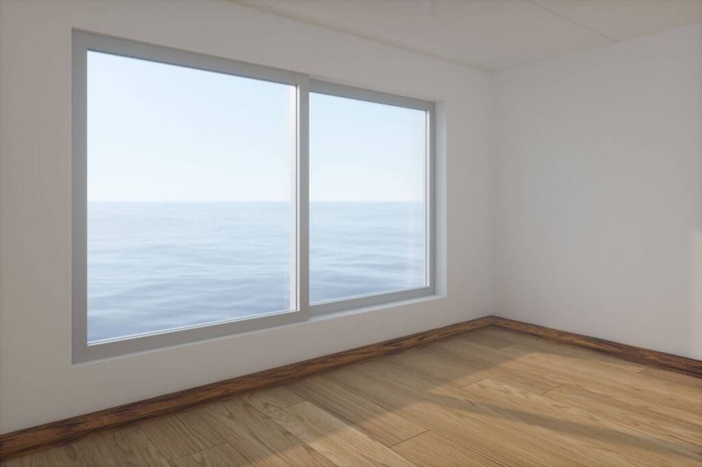 A window in an empty white-walled and hardwood floored room