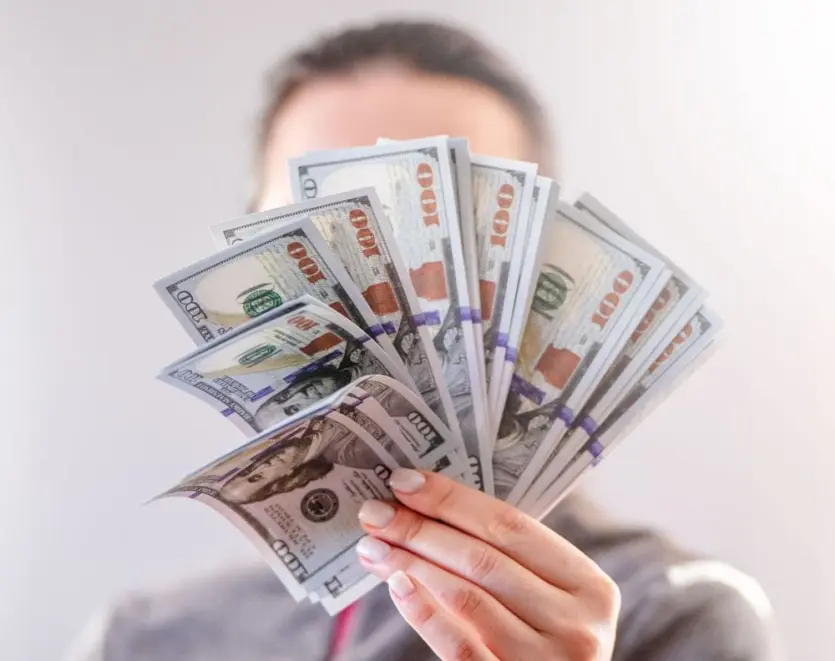 Person Holding Money In Hand