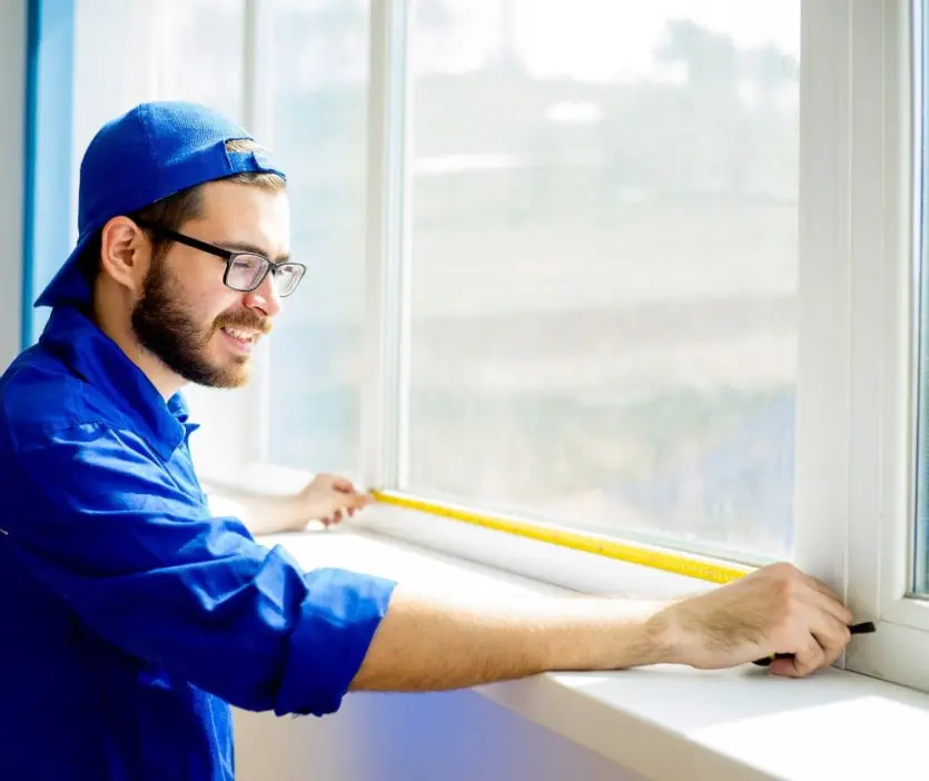 Technician Measuring Window For Installation
