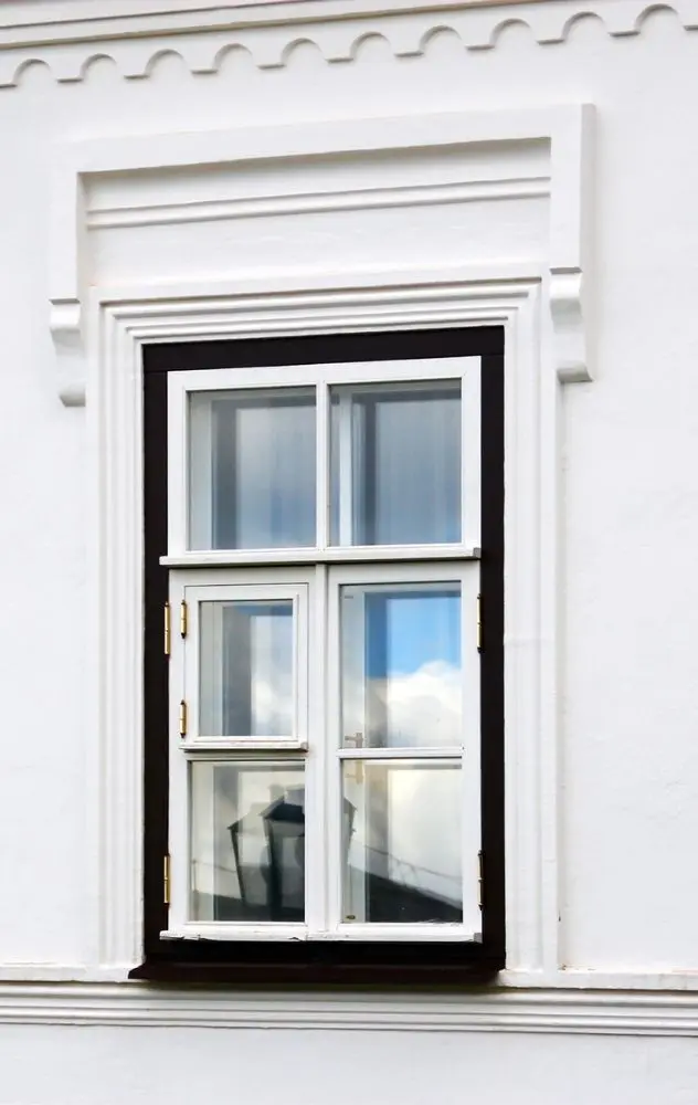 Classic White Exterior Window With Decorative Trim