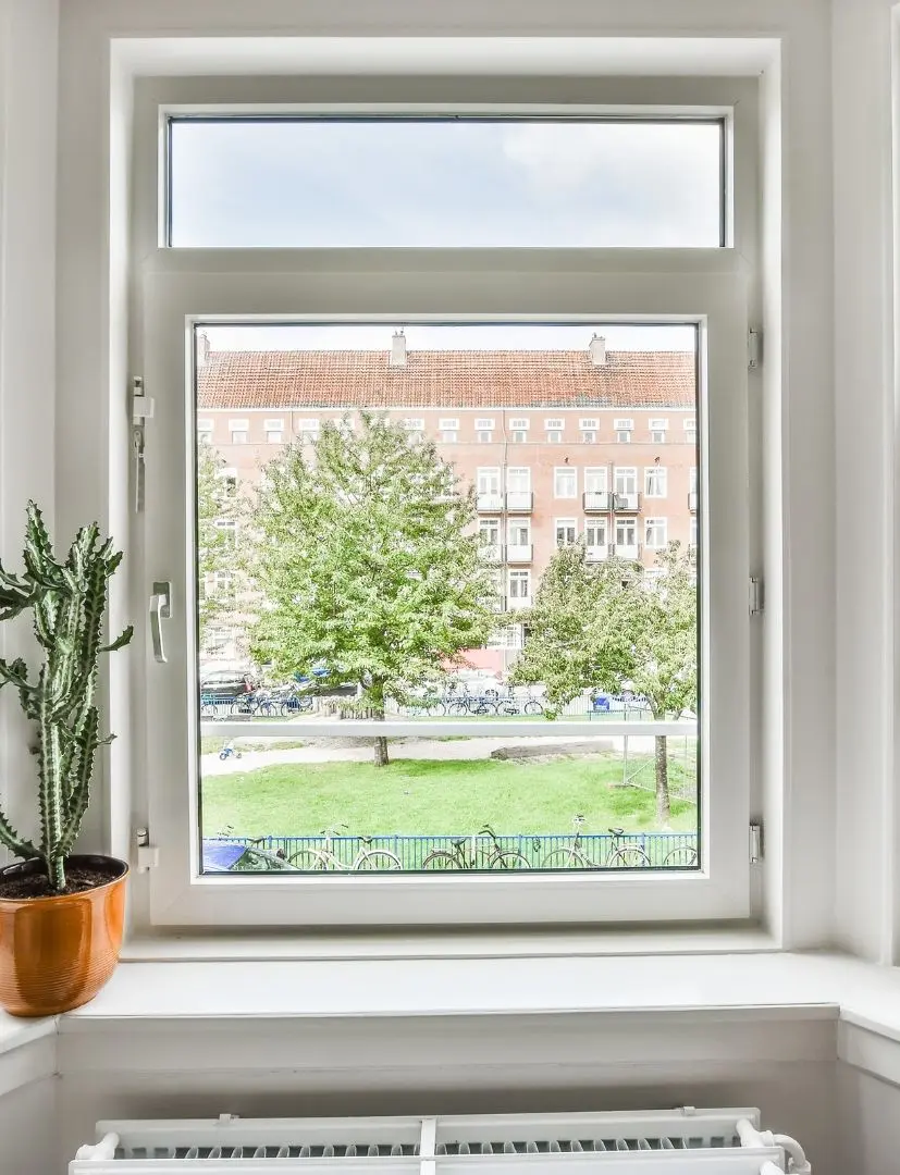 Large Window View Over Green Park And Buildings