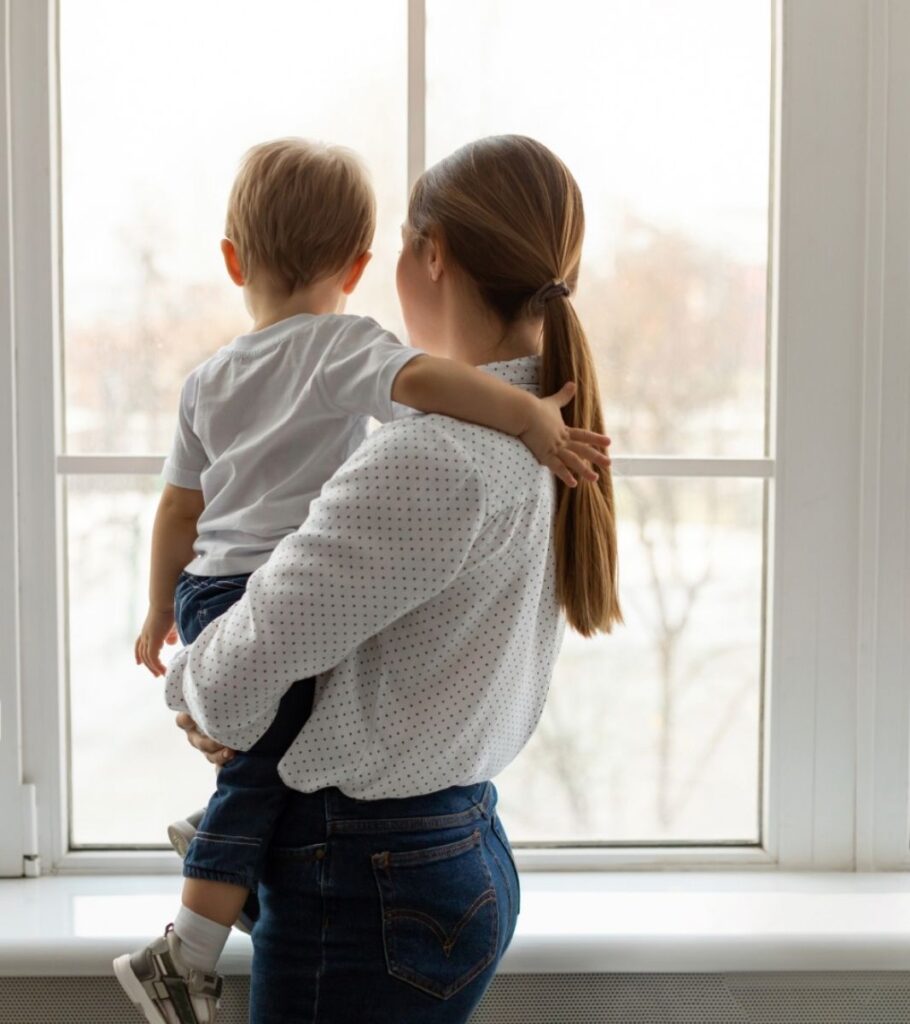 Family Standing Near Hurricane Window