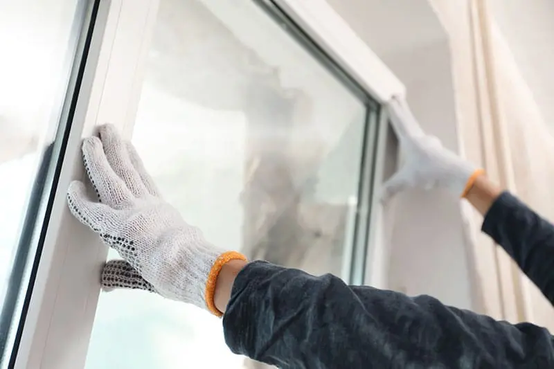 Professional Window Installation With Protective Gloves
